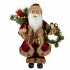 Northlight 18" Red Santa Claus Holding A Wreath And Gift Bag Christmas Figurine